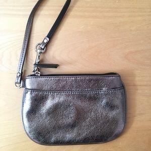 Silver coach clutch wristlet